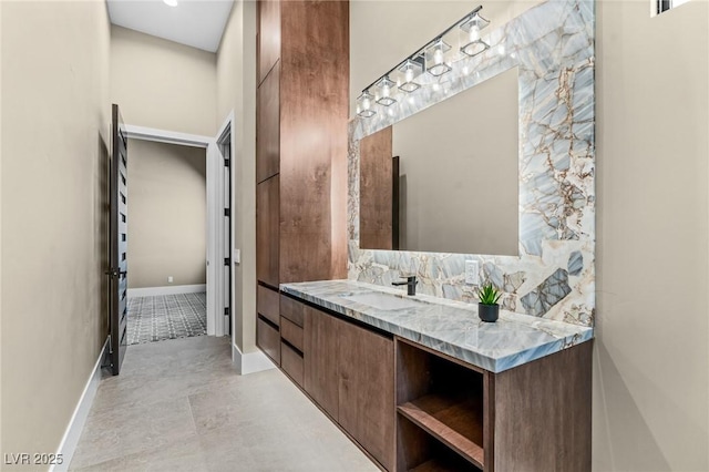 bathroom featuring baseboards and vanity