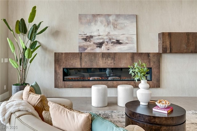 living room featuring a glass covered fireplace