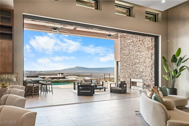 view of patio / terrace with a fenced in pool, a mountain view, an outdoor living space, and ceiling fan