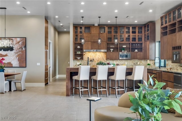 kitchen featuring a breakfast bar, modern cabinets, a sink, and stainless steel appliances
