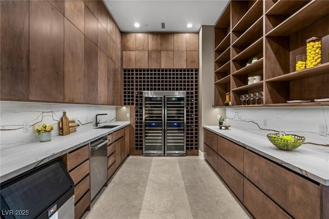 wine area featuring recessed lighting, wine cooler, and a sink