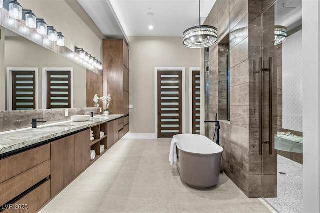 bathroom featuring a sink, double vanity, a tile shower, and a freestanding tub