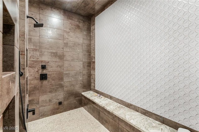 bathroom with a tile shower