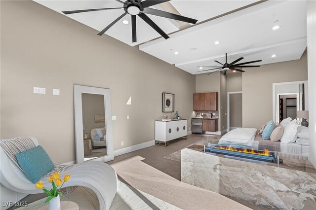 bedroom featuring baseboards, a high ceiling, ceiling fan, and recessed lighting