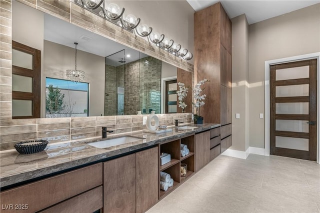 bathroom featuring backsplash, vanity, and baseboards