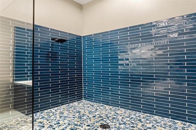 full bathroom with tiled shower