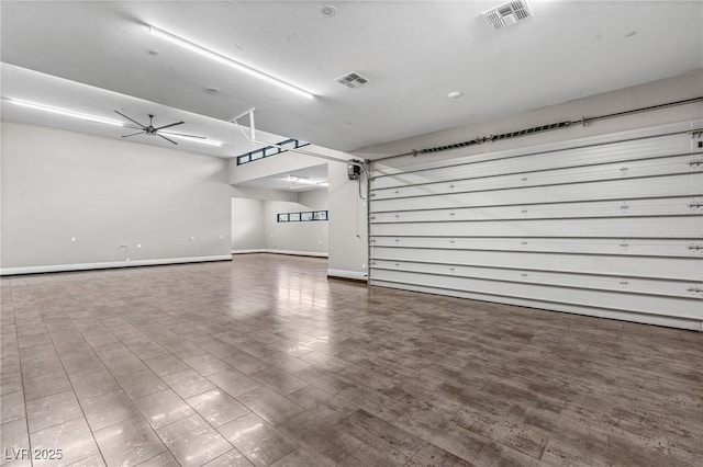 garage featuring a ceiling fan, baseboards, and visible vents