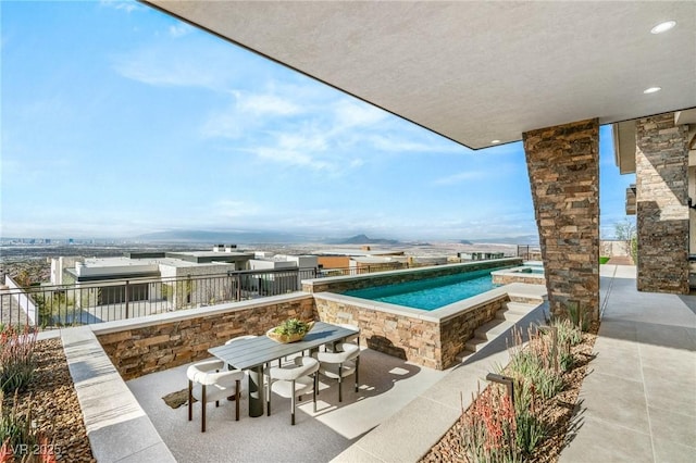 outdoor pool featuring outdoor dining area and a patio area