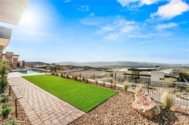 view of yard featuring a pool with connected hot tub, fence, and a patio area