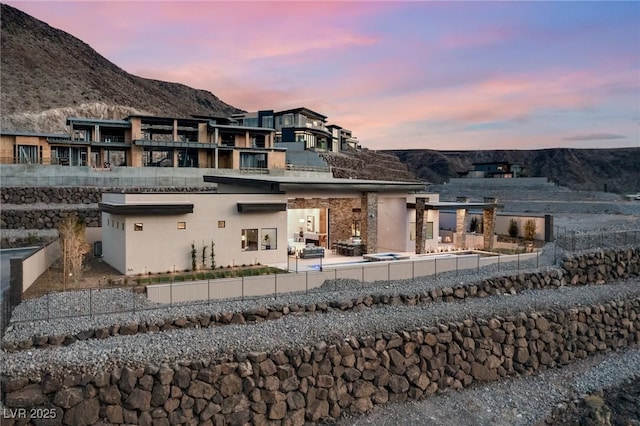 back of property featuring a patio area, stucco siding, fence, a balcony, and a mountain view