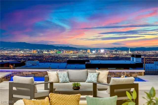 view of patio / terrace featuring an outdoor hangout area, a view of city, and a mountain view