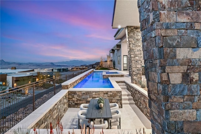 view of pool featuring fence, a fenced in pool, a patio area, and an in ground hot tub