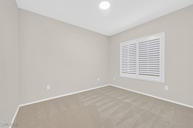 unfurnished room with carpet and baseboards