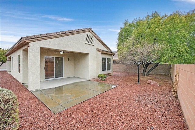 back of house featuring stucco siding, a fenced backyard, ceiling fan, and a patio