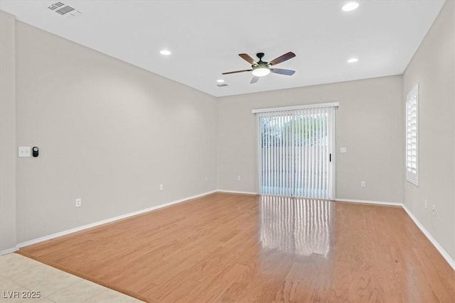 empty room with recessed lighting, baseboards, visible vents, and light wood finished floors