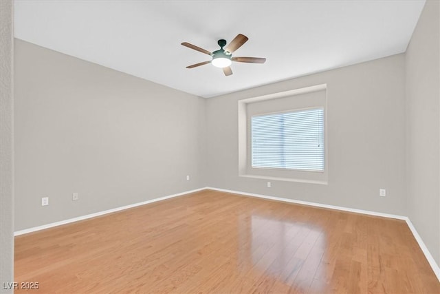 unfurnished room with ceiling fan, baseboards, and wood finished floors