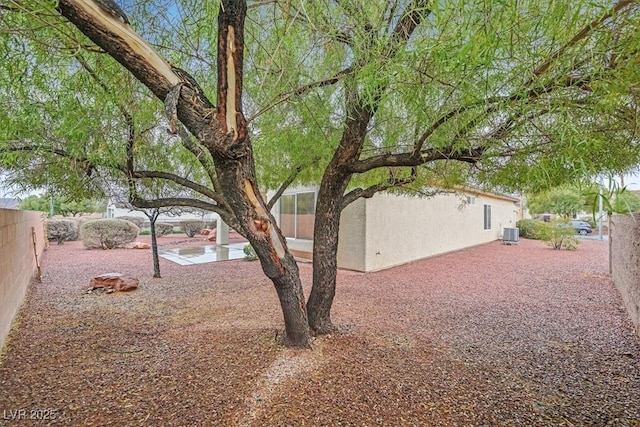 view of yard with a patio area, fence private yard, and central air condition unit