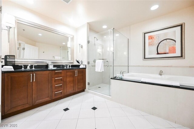 145 E Harmon Ave Unit 2503, Las Vegas, NV 89109 - bathroom featuring double vanity, a stall shower, a bath, a sink, and recessed lighting