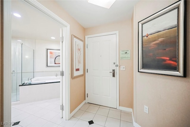 foyer featuring light tile patterned floors and baseboards