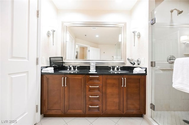 full bathroom featuring tile patterned floors, a sink, a shower stall, and double vanity