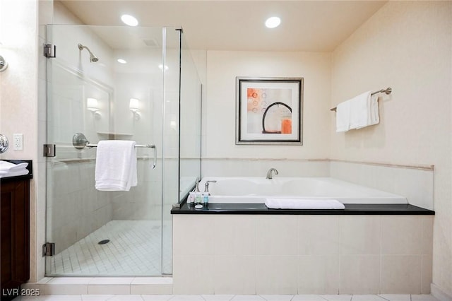 bathroom with a garden tub, recessed lighting, vanity, and a stall shower