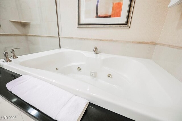 full bathroom featuring a tub with jets and tile patterned floors