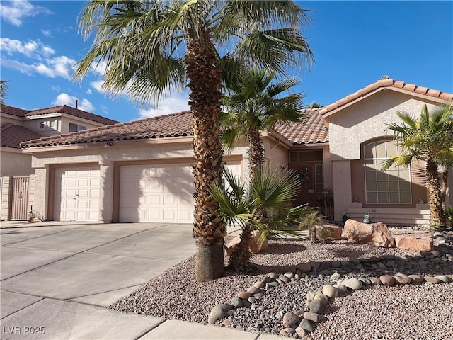 view of home's exterior featuring a garage, concrete driveway, a tiled roof, and stucco siding