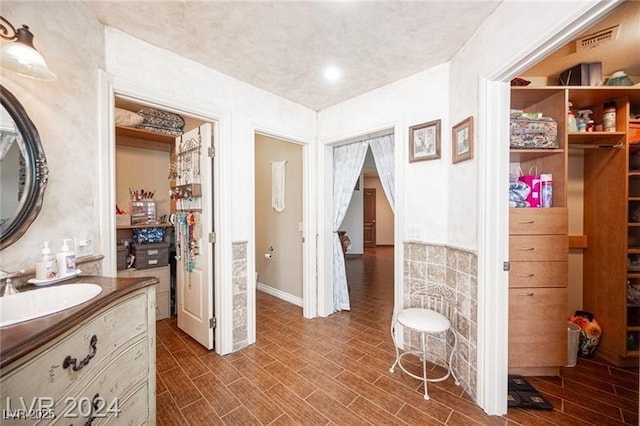 bathroom with vanity, visible vents, and wood finish floors