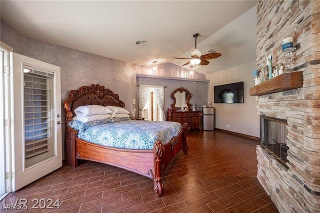 bedroom featuring wood tiled floor, visible vents, vaulted ceiling, and freestanding refrigerator