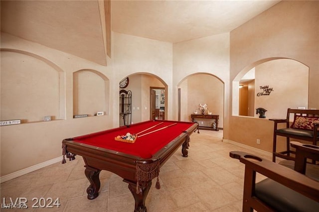 recreation room featuring arched walkways, billiards, and baseboards