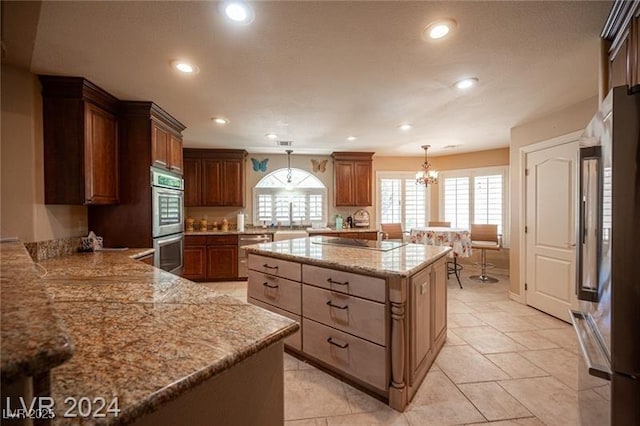 kitchen featuring a healthy amount of sunlight, appliances with stainless steel finishes, pendant lighting, and a sink