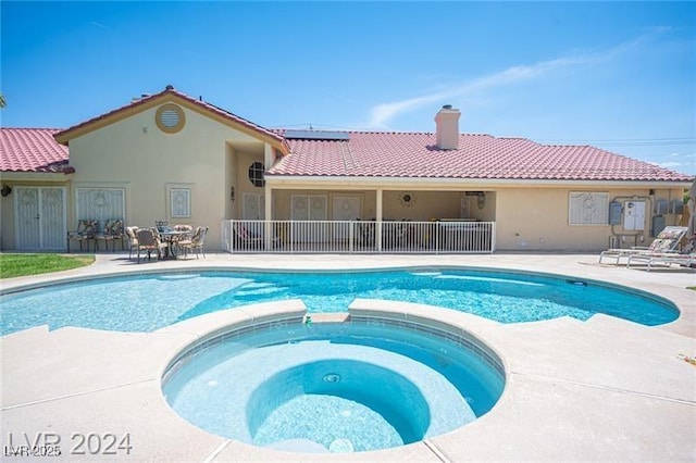 view of pool featuring a pool with connected hot tub and a patio