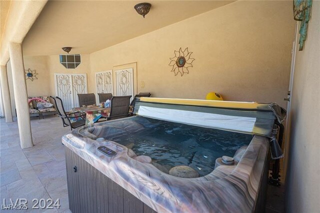 view of patio with an indoor hot tub