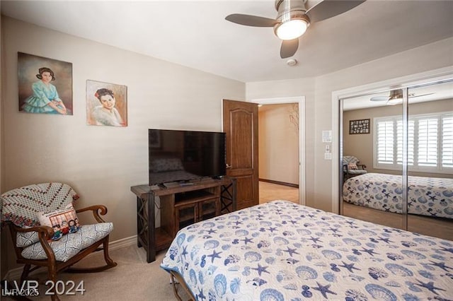 bedroom with light carpet, baseboards, and a ceiling fan