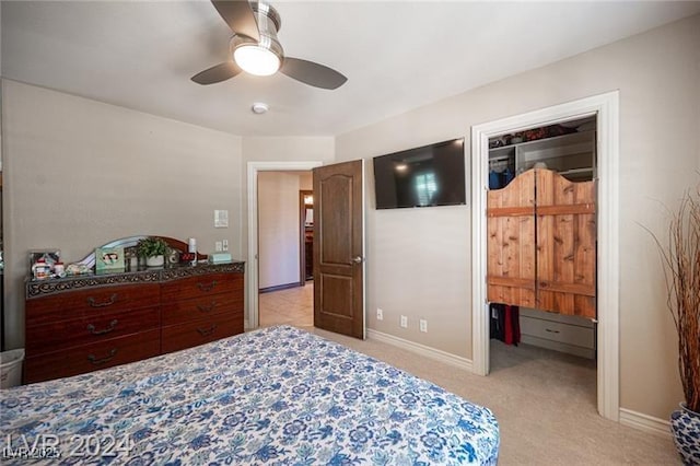 bedroom with a ceiling fan, light colored carpet, and baseboards