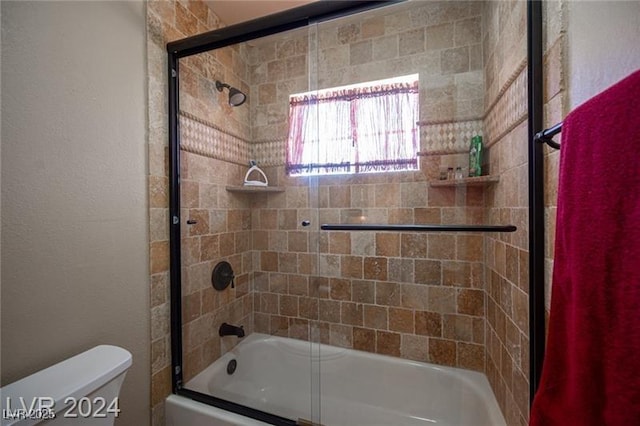 full bathroom featuring shower / bath combination with glass door and toilet