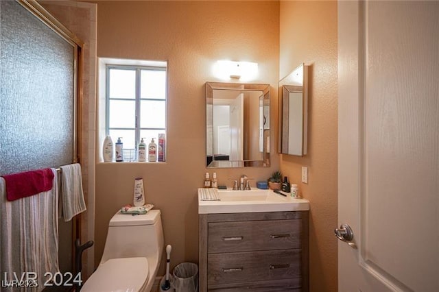 bathroom featuring vanity and toilet