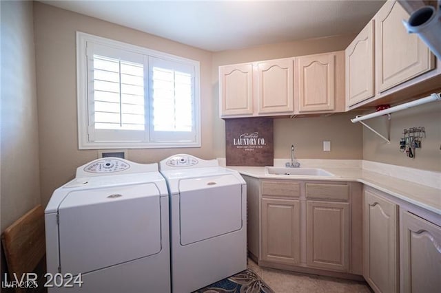 laundry room with cabinet space, a sink, and independent washer and dryer