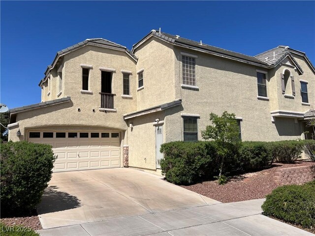 2461 Brooklyn Bridge St, Las Vegas, NV 89135 - view of front facade featuring a tiled roof, a garage, concrete driveway, and stucco siding
