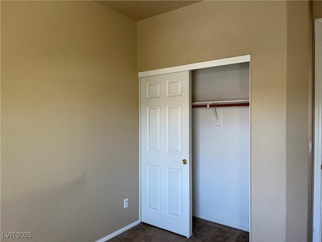 2461 Brooklyn Bridge St, Las Vegas, NV 89135 - unfurnished bedroom with baseboards, a closet, and dark colored carpet