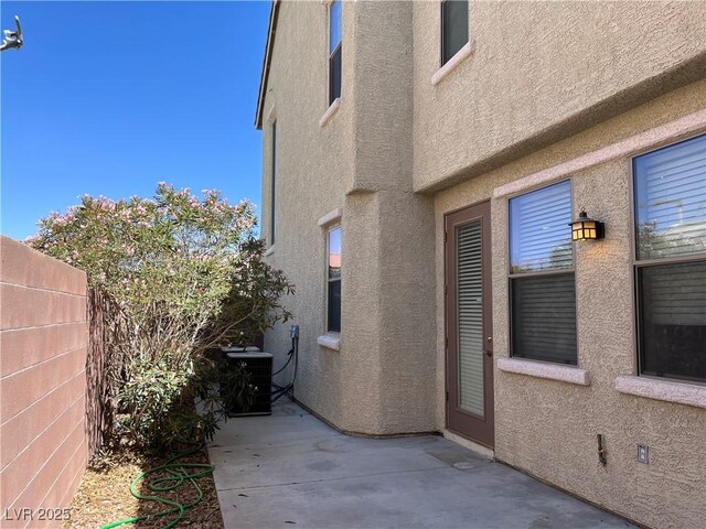 2461 Brooklyn Bridge St, Las Vegas, NV 89135 - exterior space featuring cooling unit, a patio area, fence, and stucco siding