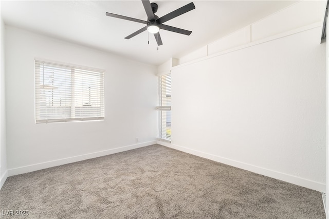 spare room with a healthy amount of sunlight, carpet flooring, and baseboards