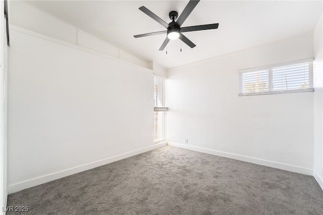 spare room featuring carpet, ceiling fan, and baseboards