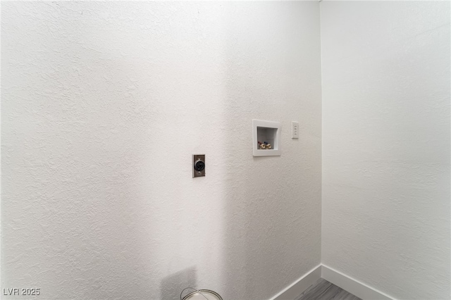 laundry room featuring laundry area, baseboards, a textured wall, hookup for an electric dryer, and washer hookup