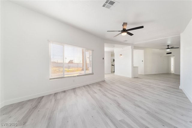 unfurnished room with light wood-type flooring, baseboards, visible vents, and ceiling fan