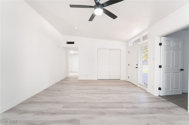 unfurnished bedroom featuring lofted ceiling, light wood finished floors, visible vents, and access to exterior