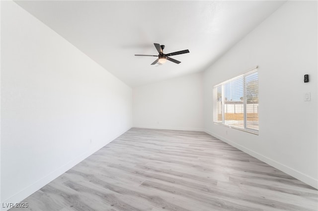 spare room with vaulted ceiling, baseboards, ceiling fan, and light wood finished floors