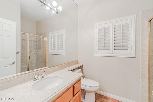 bathroom featuring tile patterned flooring, toilet, vanity, baseboards, and a shower stall