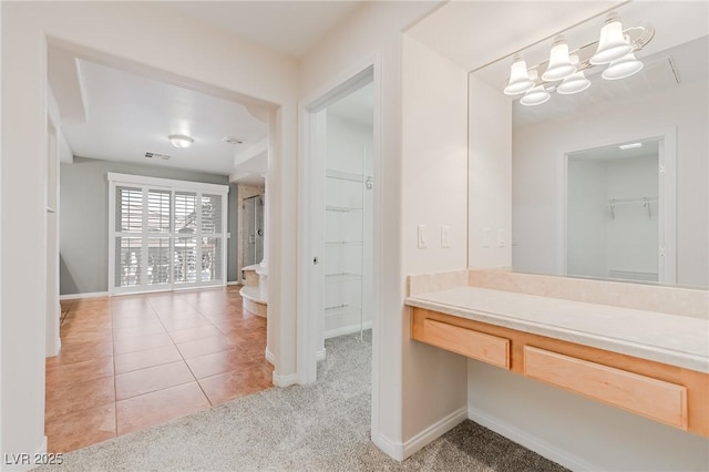 bathroom with a notable chandelier, tile patterned flooring, visible vents, and baseboards