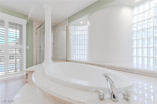 bathroom with a bath, a stall shower, decorative columns, and tile patterned floors